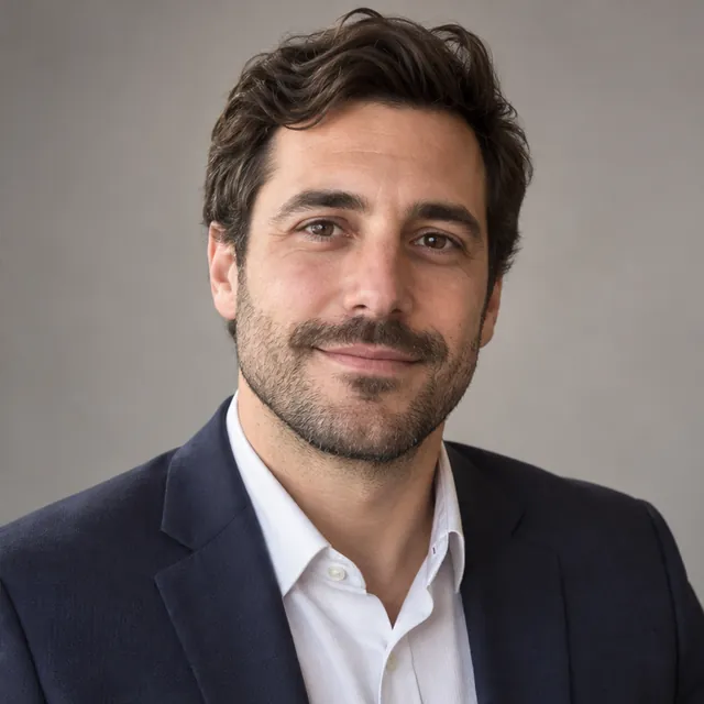 The same man in a polished professional profile headshot